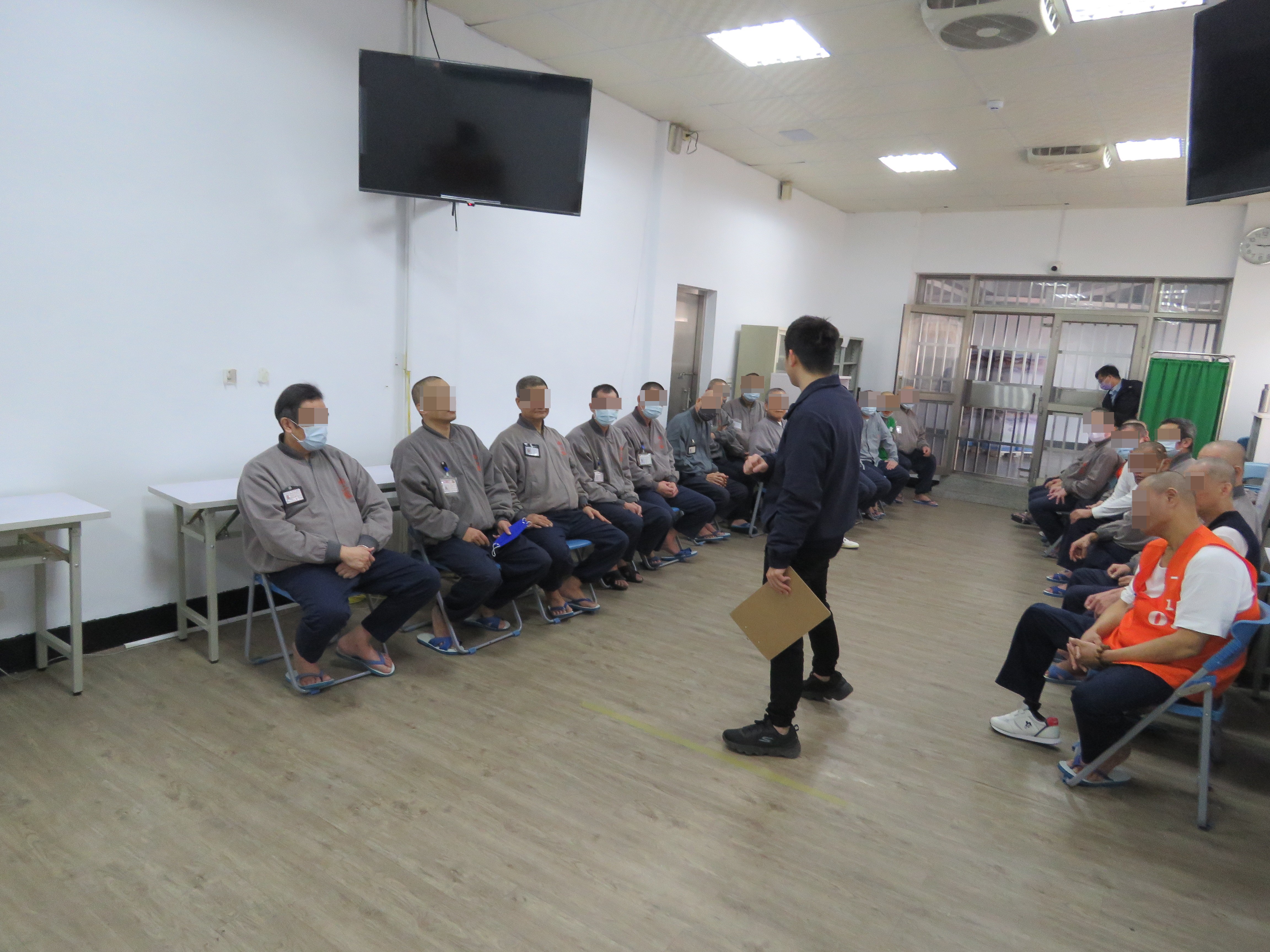 教誨師向身心障礙及高齡組示範九宮格投擲比賽規則